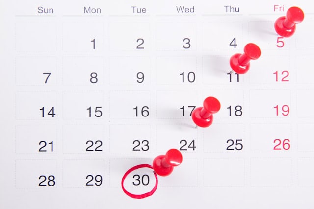 Editorial calendar with red pins.