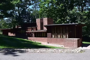Usonian style house in a wooded lot.