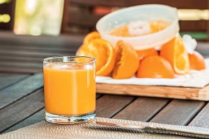 The Trusting Indirect Tone In Ai Personas 1 Freshly squeezed orange juice on a table.