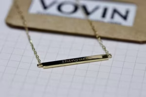 Gold jewelry on a white surface.