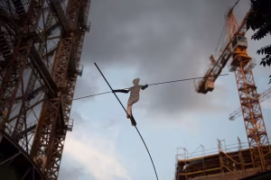 Sculpture of a figure on a tightrope.