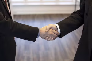 Two business people shaking hands in trust.