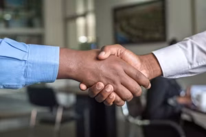 Two hand shaking to show trust.