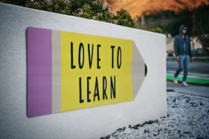 The Architect'S Voice: Mastering The Instructive Tone In Ai Personas 3 A white wall with love to learn on it.