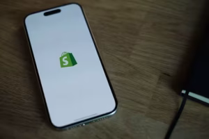 Shopify logo on a smartphone.
