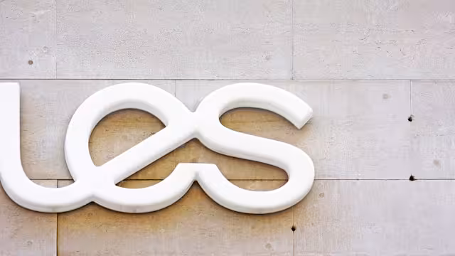White lettermark logo on a building.