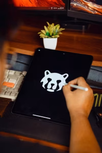 A person designing a logo on a tablet.