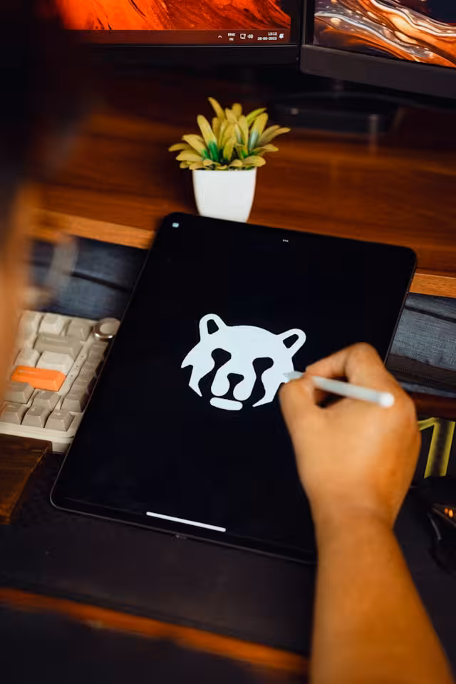 A person designing a logo on a tablet.