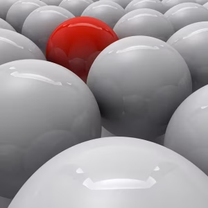 A red ball in a group of gray balls.