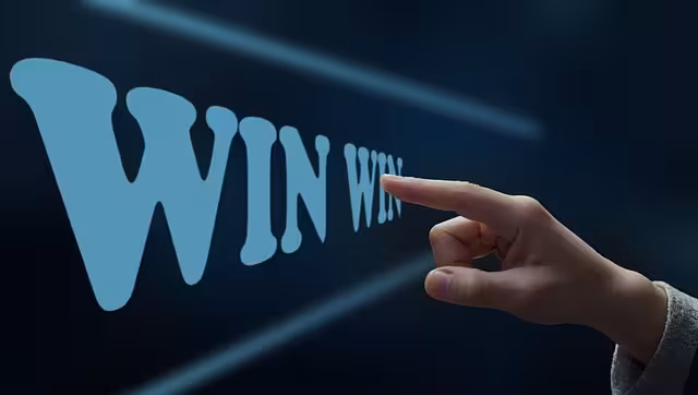 A finger pointing at win-win with black background.